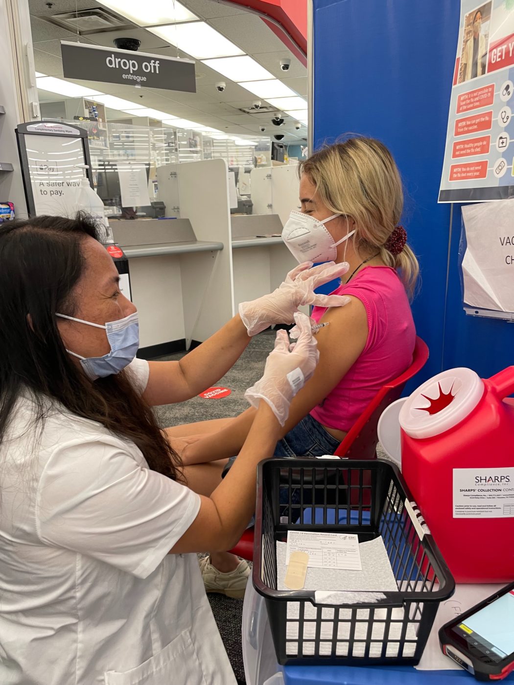 Pharmacist provides a vaccine to a young individual.